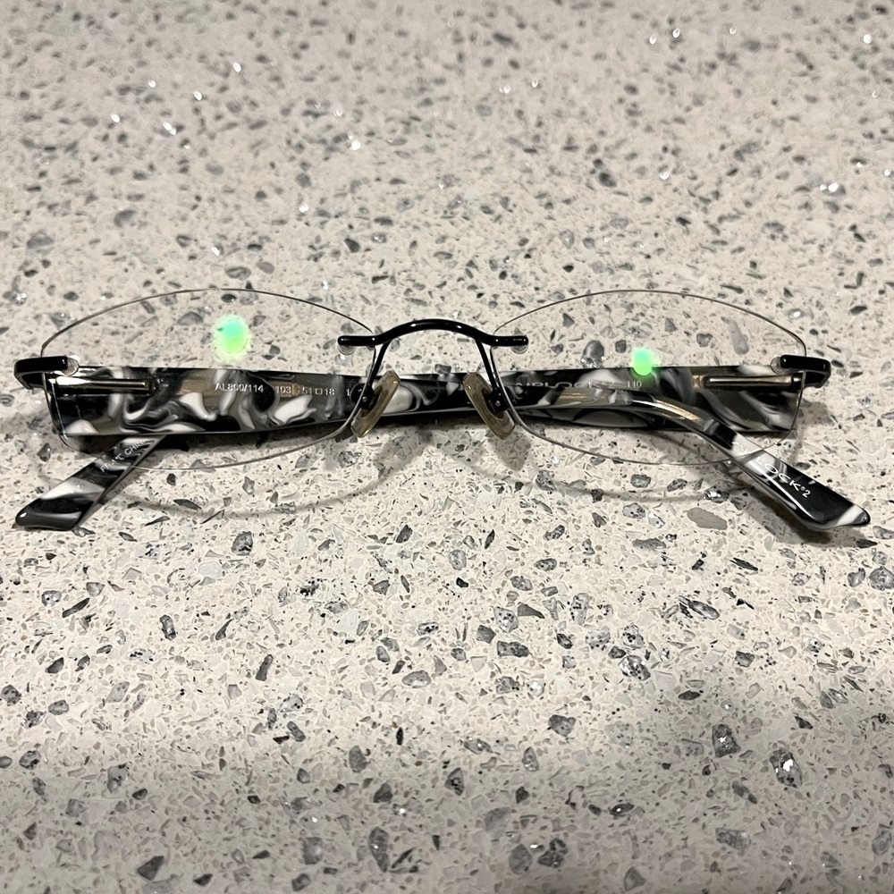 Airlock Rimless Frames in Black/White w/ Black Metal Front. B & W Plastic Temple